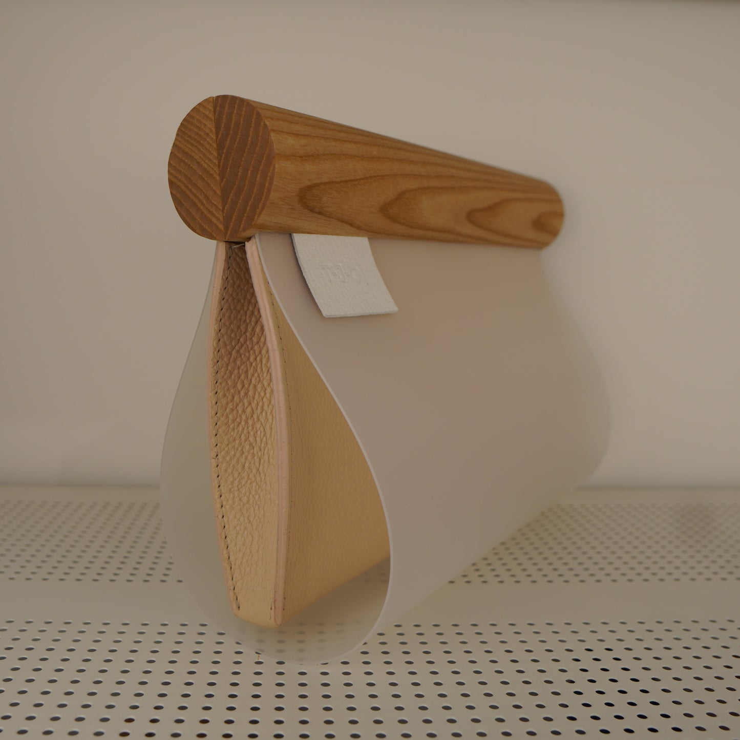 A modern design object - handbad, designed from wood, leather and plastic. Hand made.